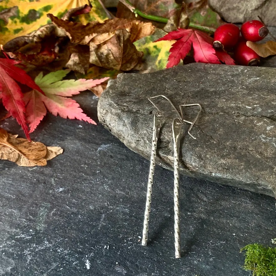 Elegant twisted silver drop earrings.