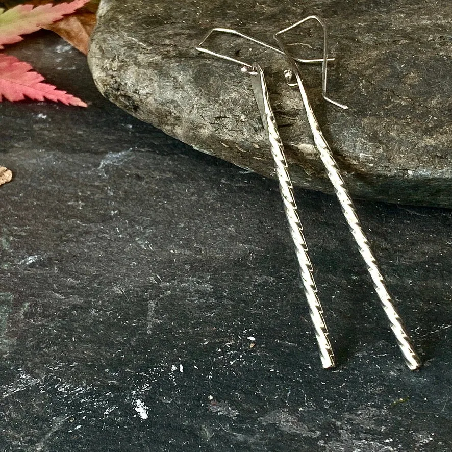 Elegant twisted silver drop earrings.